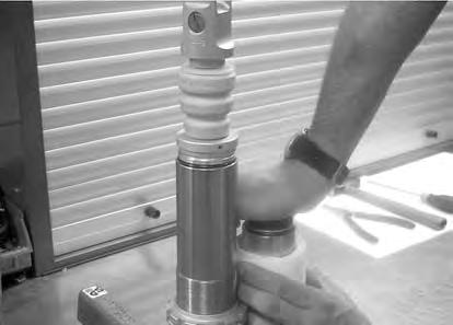 Push the floating piston quickly down to reservoir bottom while holding the rod steady in the appropriate position for top-up.