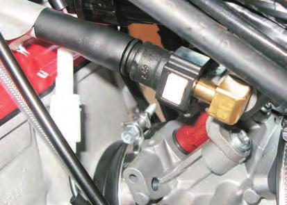 The electronic control unit (5) located under the saddle signals the injector to open and a fan-shaped spray of fuel is injected into the combustion chamber.