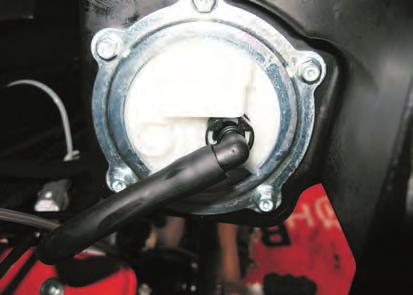 - Disconnect the hose (13) connecting tank to throttle body; press down the