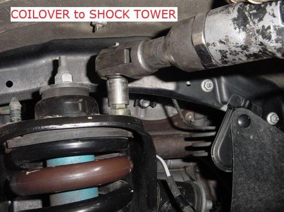 12. Being careful not to overextend and pull apart the inner CV Axle joint, move the spindle/hub assembly out of the way and remove the coilover from the vehicle 13.