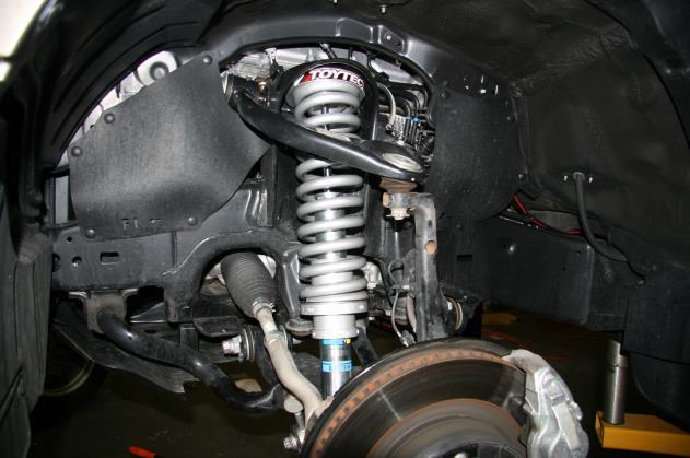 Install the lower shock bolt and nut. You may need to pry down on the upper control arm in order to get the lower shock bolt installed. Torque upper nuts and lower bolt/nut to manufacture specs.