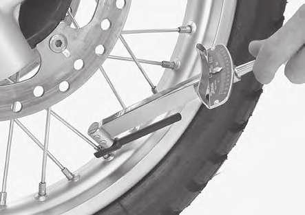 Tap on the spokes and be sure that the same clear metallic sound can be heard on all spokes. Inspect the spokes for looseness by tapping them with a screwdriver.