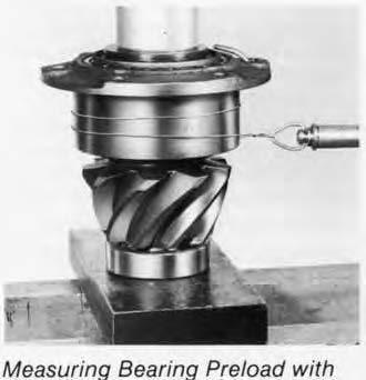 Either install the yoke (or helical gear) and torque the pinion nut to specifications or use a press to simulate nut torque (see chart below).