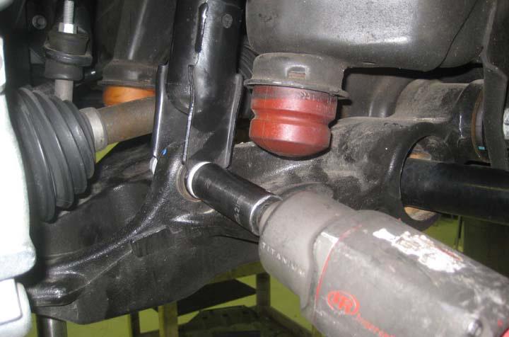 Working on the driver side, place a hydraulic floor jack under the driver side lower control arm and