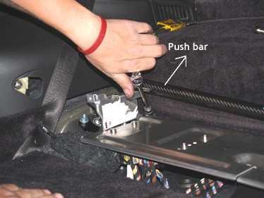 23. To re-attach, push the carbon fiber bar back against the carpeting until it can slide into the mounting bracket.