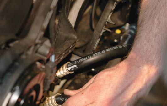 93. Press the two transmission cooler lines back into the retainer