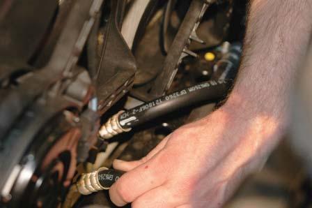 Push down on the top of the Transmission Heat Exchanger hoses so