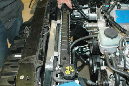 Refer to steps 59 thru 61 to reinstall the plastic upper radiator mounts to secure the radiator back in place; then reinstall the bracket locking tabs.