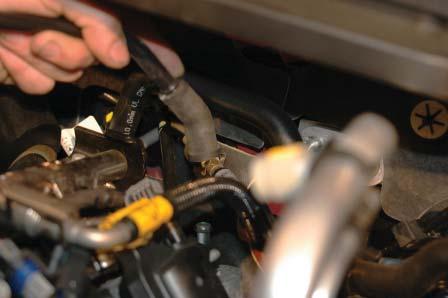 Remove the PCV hose from the rear driv- er side barb and