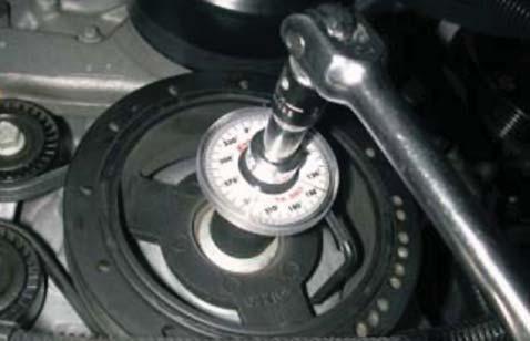 53. Using a 24mm socket tighten the new Harmonic Balancer bolt according to General Motors specifi cations.