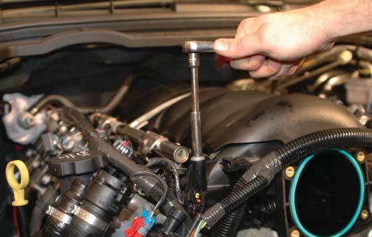 21. Pull off the retaining clip, and using the fuel line removal tool supplied, remove the fuel line