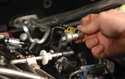 To ease removal, pull the fuel line forward, then insert the disconnect tool.