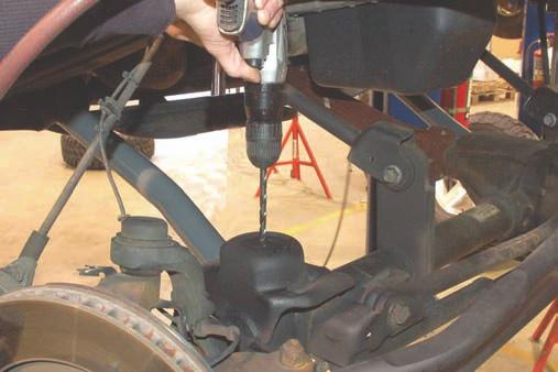 11. Install the new control arms in the upper mount as shown in Photo 5 with the stock hardware. 12. Install the arm on the axle with the stock hardware.