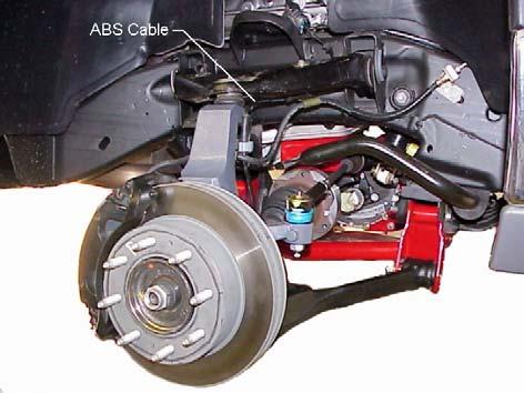 4) Apply thread lock to original bolts and attach the hub and bearing assembly to the left steering knuckle. Refer to illustration #13. Tighten the mounting bolts to 133 ft. lbs.