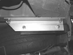 On LHS pass the long Bolt/Plate/Wire ASM down the inside of the chassis rail, then locate the 2 bolts through