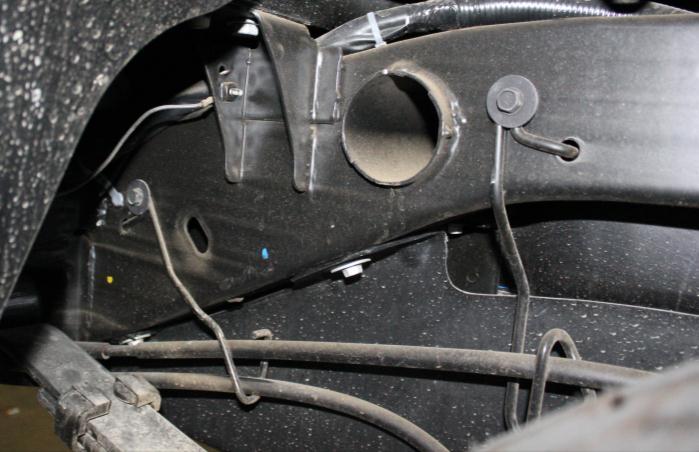 4) Remove the e-brake cable bracket on the driver s side of the frame and
