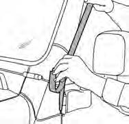 Hook the center strap around the spare tire carrier and the outside straps around each taillight.