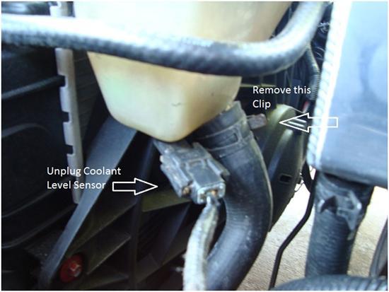 5. After removing the overflow hose use the pliers again to remove the spring style clamp at the lower radiator hose.