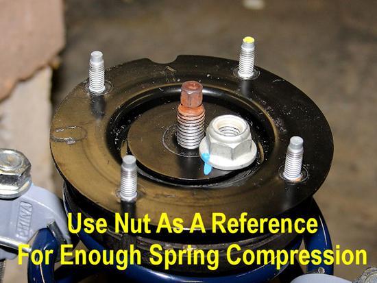 20. Use the strut s nut as a reference point to determine if you have compressed the spring enough for installation.
