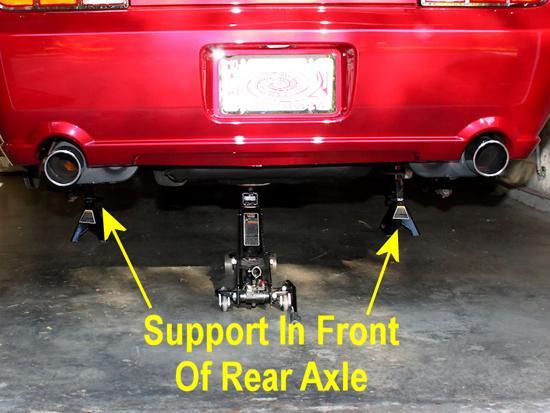 You do not want to support the car by the rear axle, as you will be lowering the