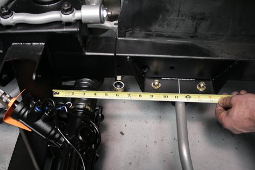 The sway bar bracket is mounted 11.25 inches from the front edge of the cross member to the center of the bracket.