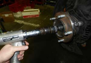(Fig 8) Taking care not to damage the threads on the axle, use an air hammer with a pointed bit in the axle and slowly press