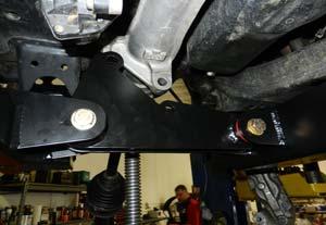 Do not tighten at this time. (Fig 23) Notch the lower control arm strut pocket as shown.