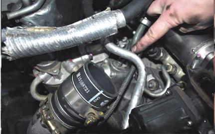 Two bolts secure the flange at one end and the four remaining bolts secure the intake tube to the EGR Valve.