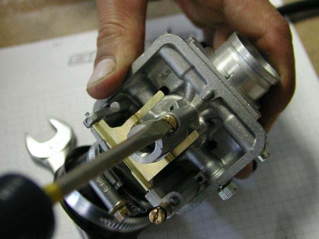 The pilot jet is located in the body of the carburetor as shown, to change it use a straight screw