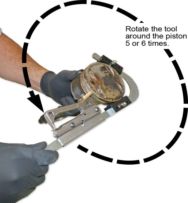 6. Hold the piston steady and rotate the tool counter-clockwise five to six times to remove any carbon deposits in the