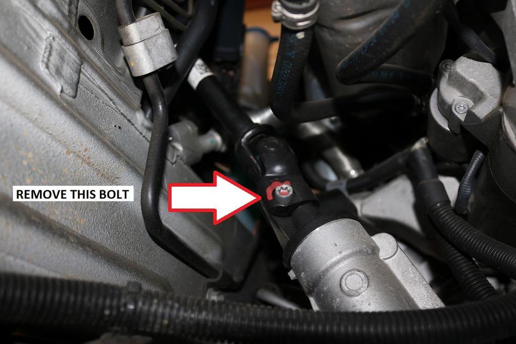 10) With the vehicle safely raised so the front suspension is completely unloaded, locate where the steering shaft