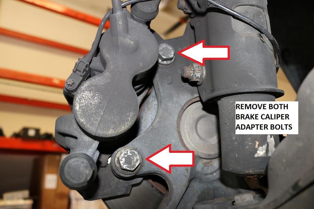 13) Use a 21mm socket to remove the front brake caliper