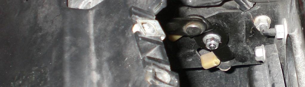 Remove the 10mm nut that holds the headlight lifting arm to the headlight motor.