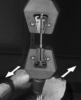 Tighten the upper grip first (Figure 7). (NOTE: The upper grip swivels on a U joint; therefore,thespecimenmaybebentifthelower grip is tightened first.