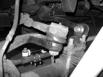 Figure 1 6. Remove the three nuts mounting the steering arm to the driver's side steering knuckle. The arm is also held in place by tapered collars at each stud.