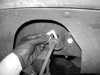 Figure 3 10. With the brake line fitting pulled out of the mount bracket, carefully cut a 1/4" wide slot in the top of the bracket through to the brake line hole.
