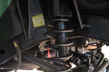 10. Once the coil spring is compressed, install it in the Jeep over the spring spacer. 12.