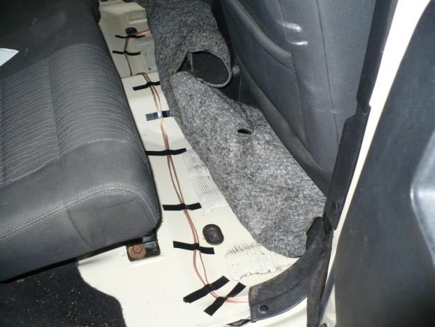 Pop out the two plastic rivets and remove some of the electrical tape. (Your wires will go under the carpet, over to the amp under the driver seat.