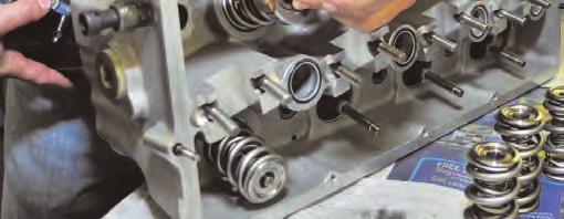 Oil is applied to the valve stems and the valves are inserted into