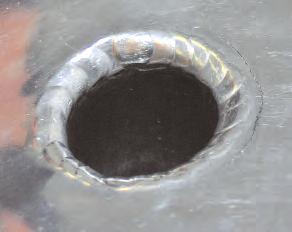 The best solution for sealing the crack around the plug hole is to apply a special silicone sealer, the cost of which is
