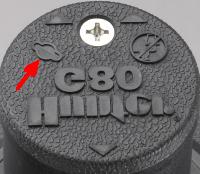 As the rubberized logo cap is removed, note there is a protruding pin on the underside of the logo cap (FIGURE 11).