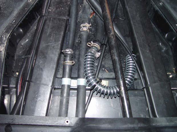 Using vice grips or any suitable clamping device, close off only theheater hose, closest to the driver s side (left), on both sides of the splice connector. REF.