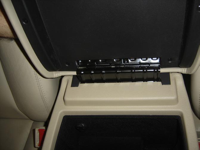 three screws securing the cup holder to the center console.