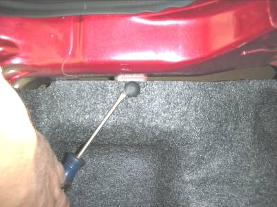 Preparation: 1) Inside of the trunk, start by removing the rear most plastic trim panel that covers the taillight wires