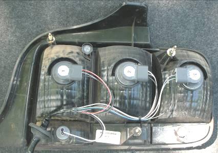 7) Wiring harness is attached to the taillight via plastic retainer, pull wiring harness and plastic retainer away from taillight to remove. Now remove wiring harness from taillight.