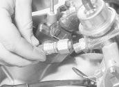 Fuel and exhaust systems - fuel-injected models 4B 11 12.73 Disconnecting the fuel return line from the fuel pressure regulator 70 Refitting is the reverse of the removal procedure.