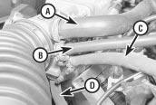 Pull the cable out of the retainer and move it aside (see 18 Remove the 9 nuts which secure the manifold to the cylinder head.