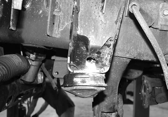 32. The lower control arm bump stop cups must be removed from the frame. Using a saw-zall or cutoff wheel, cut the weld beads holding the bump stop cups to the frame (Fig 13 A/B).