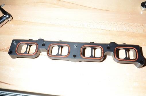 7 Be sure the four gaskets are installed into the adapter plate, as shown. Make sure each one is fully seated.