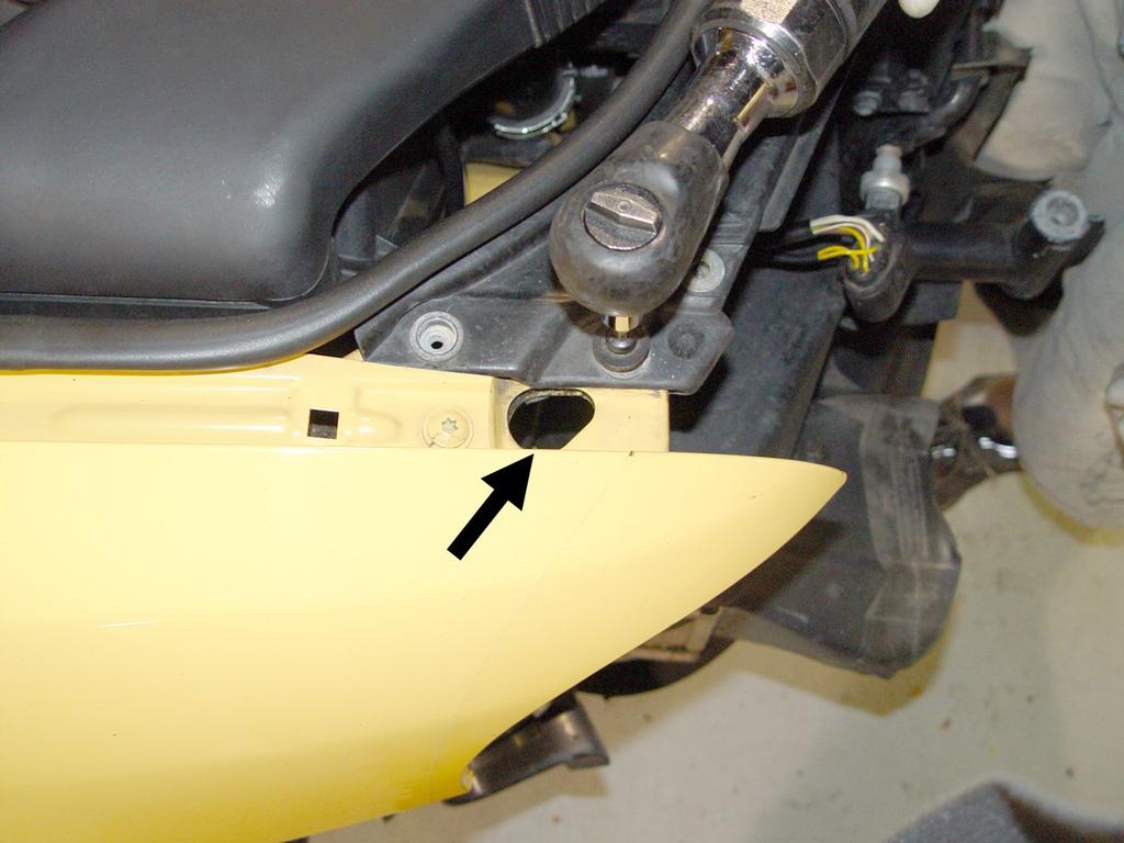 Pull the bumper forward to expose the headlight washer hoses by the driver side headlight.